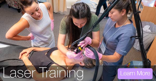 students learn cosmetic lasers with experienced teacher during cosmetic laser training certification.